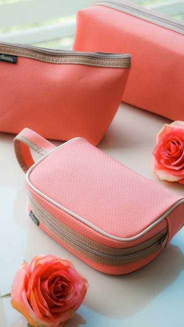 Pink cosmetic bags beautifully arranged with roses, perfect for a stylish display or mobile wallpaper.